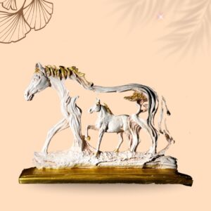 Handcrafted horse and foal statue with golden accents on a wooden base