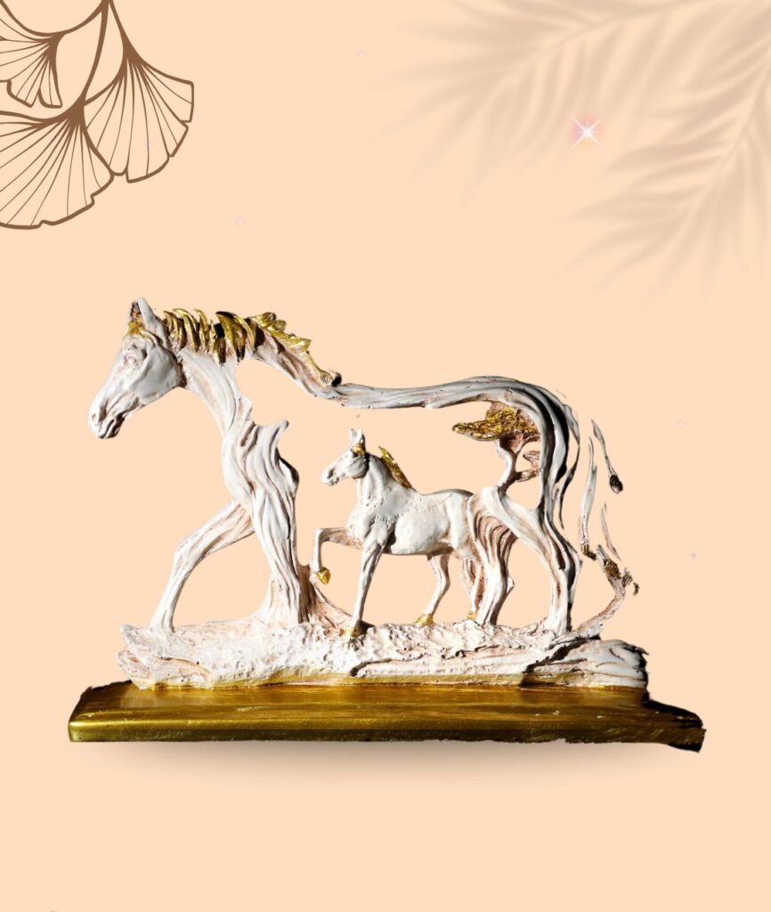Handcrafted horse and foal statue with golden accents on a wooden base